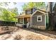Exterior view of a charming gray home with a covered porch, manicured yard, and mature trees at 1326 Metropolitan Se Ave, Atlanta, GA 30316