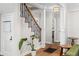 Hallway featuring hardwood floors, white trim, and a staircase with wrought iron accents at 1326 Metropolitan Se Ave, Atlanta, GA 30316