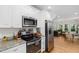 Modern kitchen featuring stainless steel appliances, granite countertops and hardwood floors at 1326 Metropolitan Se Ave, Atlanta, GA 30316
