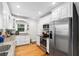 Well-lit kitchen featuring white cabinets, stainless steel appliances, and granite countertops at 1326 Metropolitan Se Ave, Atlanta, GA 30316