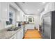 Well-lit kitchen featuring white cabinets, stainless steel appliances, and granite countertops at 1326 Metropolitan Se Ave, Atlanta, GA 30316