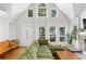 Inviting living room with vaulted ceilings, large windows, and a cozy green sectional sofa at 1326 Metropolitan Se Ave, Atlanta, GA 30316