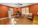 Sunlit office featuring hardwood floors, an orange accent wall and a classic patterned chair at 1326 Metropolitan Se Ave, Atlanta, GA 30316