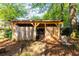 View of a wooden storage shed in a backyard setting, surrounded by green trees and foliage at 1326 Metropolitan Se Ave, Atlanta, GA 30316