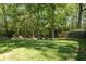 Lush backyard with a privacy fence and mature trees at 1570 Hill Crossing Ct, Grayson, GA 30017