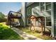 Backyard of gray house with a deck, pet cage and sidewalk at 1570 Hill Crossing Ct, Grayson, GA 30017