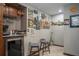 Basement bar with a sleek mini fridge, barstools, granite countertop, and decorative wall art at 1570 Hill Crossing Ct, Grayson, GA 30017