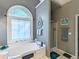 Bathroom with soaking tub under window and separate shower at 1570 Hill Crossing Ct, Grayson, GA 30017