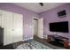 Bedroom with lavender walls, gray flooring, and a ceiling fan at 1570 Hill Crossing Ct, Grayson, GA 30017