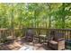Cozy deck with comfortable seating, perfect for relaxing in a serene, natural setting at 1570 Hill Crossing Ct, Grayson, GA 30017