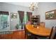 Traditional dining room with wood table and chairs, chandelier, and large window offering natural light at 1570 Hill Crossing Ct, Grayson, GA 30017