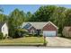 Inviting single-Gathering home with beautiful lawn, complemented by mature trees in a serene setting at 1570 Hill Crossing Ct, Grayson, GA 30017