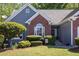 Captivating home with manicured lawn, mature trees, and charming shrubbery along the front entrance at 1570 Hill Crossing Ct, Grayson, GA 30017