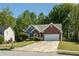 Lovely single-story home with brick accents, complemented by a well-maintained lawn and driveway at 1570 Hill Crossing Ct, Grayson, GA 30017