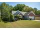 Beautiful home with a lush green lawn and mature trees, offering a peaceful and inviting atmosphere at 1570 Hill Crossing Ct, Grayson, GA 30017