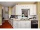 A view of the kitchen featuring white cabinetry, sleek countertops, and stainless steel appliances at 1570 Hill Crossing Ct, Grayson, GA 30017