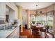 Kitchen area with stainless sink and adjacent breakfast nook with natural light and plants at 1570 Hill Crossing Ct, Grayson, GA 30017