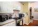 A view of the kitchen featuring a black stove, microwave, and white countertop space at 1570 Hill Crossing Ct, Grayson, GA 30017