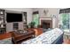 Inviting living room featuring a fireplace, large windows, and stylish furniture, creating a warm ambiance at 1570 Hill Crossing Ct, Grayson, GA 30017