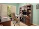 Home office with large wooden desk, built-in shelving, and natural light from a large window at 1570 Hill Crossing Ct, Grayson, GA 30017