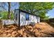 Backyard featuring a partially fenced yard, shade trees, and side view of the house with white siding at 2077 Perkerson Rd, Atlanta, GA 30310
