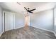 Neutral bedroom featuring modern ceiling fan, closet, and wood-look flooring with grey walls at 2077 Perkerson Rd, Atlanta, GA 30310