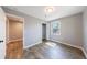 Bedroom featuring wood-look flooring, neutral walls, a closet, and natural light from the window at 2077 Perkerson Rd, Atlanta, GA 30310