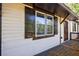 Exterior view features a side deck with black railing and white siding with black-trimmed windows and door at 2077 Perkerson Rd, Atlanta, GA 30310