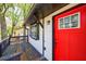 A close-up view of the home's exterior showcasing a bright red door and inviting front porch at 2077 Perkerson Rd, Atlanta, GA 30310