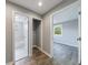 Hallway view featuring a bathroom and bedroom showcasing grey walls and wood-look flooring at 2077 Perkerson Rd, Atlanta, GA 30310