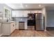 Updated kitchen with granite counters, backsplash, new stainless steel appliances, and modern hardware at 2077 Perkerson Rd, Atlanta, GA 30310