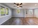 Bright living room with modern ceiling fan, lots of windows, and convenient closet space at 2077 Perkerson Rd, Atlanta, GA 30310