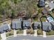 Aerial view of the home in a neighborhood with manicured lawns, mature trees, and a community pool at 815 Commerce Trl, Canton, GA 30114