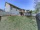Large green backyard with a trampoline, deck, and view of the house exterior with neutral siding at 815 Commerce Trl, Canton, GA 30114