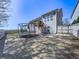 Spacious fenced backyard with a trampoline, small stone area, and a home exterior with windows and deck at 815 Commerce Trl, Canton, GA 30114