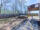 Fenced backyard featuring a trampoline, stone walkway, and access to an elevated deck with privacy at 815 Commerce Trl, Canton, GA 30114