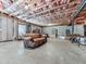 Spacious unfinished basement with a comfy leather sofa, exposed ceiling and insulated walls at 815 Commerce Trl, Canton, GA 30114