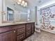 Bathroom with double sink vanity, neutral paint, large mirror, and shower with floral curtain at 815 Commerce Trl, Canton, GA 30114