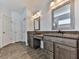 Bathroom featuring dual vanities with granite countertops and a shared space to sit and get ready at 815 Commerce Trl, Canton, GA 30114