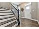 Welcoming entryway featuring hardwood floors, a staircase, and a charming window above the door at 815 Commerce Trl, Canton, GA 30114