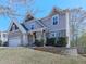 Attractive two-story home featuring a brick-accented garage, cozy front porch, and a landscaped front yard at 815 Commerce Trl, Canton, GA 30114
