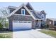 Beautiful home with a two-car garage, accented by brickwork and a well-kept lawn at 815 Commerce Trl, Canton, GA 30114