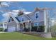 Inviting two-story home with a brick-accented garage, charming front porch, and a landscaped front yard at 815 Commerce Trl, Canton, GA 30114