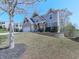 Charming two-story home featuring a brick-accented garage and a beautifully landscaped front yard on a slope at 815 Commerce Trl, Canton, GA 30114