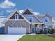 Charming two-story home featuring a brick and siding exterior, complemented by a well-manicured front yard at 815 Commerce Trl, Canton, GA 30114
