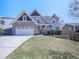 Inviting two-story home with a charming front porch, brick and siding exterior, and a well-manicured lawn at 815 Commerce Trl, Canton, GA 30114