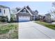 Traditional home featuring a brick and siding exterior, large driveway, and well-manicured lawn at 815 Commerce Trl, Canton, GA 30114