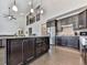 Open kitchen and living room, with stainless appliances, dark cabinets, and island seating at 815 Commerce Trl, Canton, GA 30114