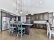 Eat-in kitchen with granite countertops, island seating, pendant lighting, and stainless appliances at 815 Commerce Trl, Canton, GA 30114
