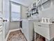 Laundry room features tile floor, window, sink, and lots of storage space at 815 Commerce Trl, Canton, GA 30114
